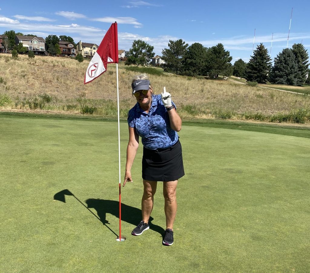 Theresa Leider celebrating a hole-in-one on a Colorado golf course